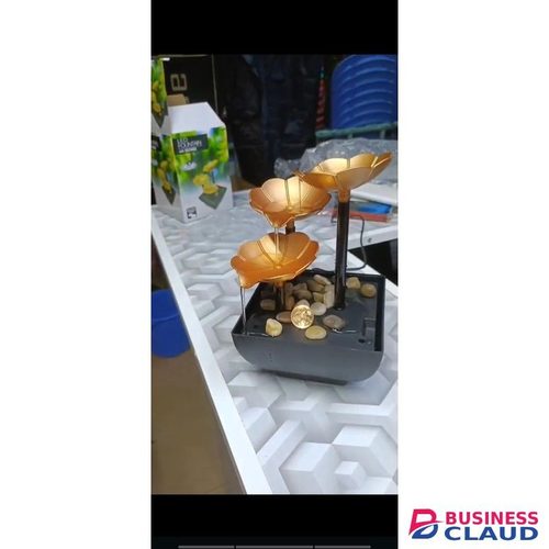 LED tabletop water fountain with a lotus design and natural river rocks