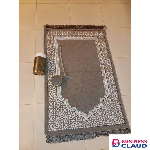 Islamic prayer mat (sajjadah) gift set, which includes the mat itself, prayer beads (tasbih), and a cylindrical gift box