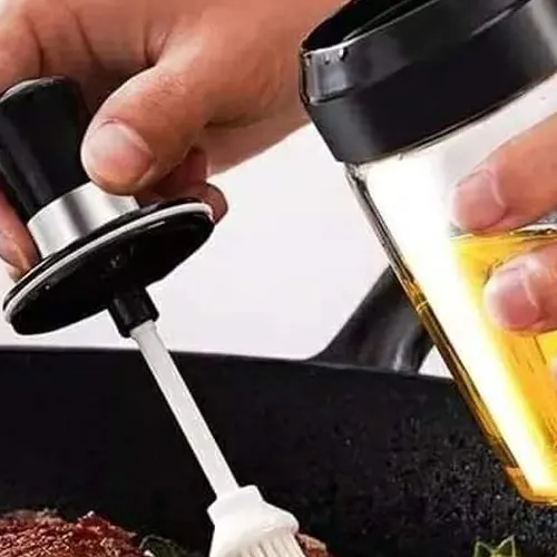 Glass jar with honey dipper oil brush or spice scooping spoon